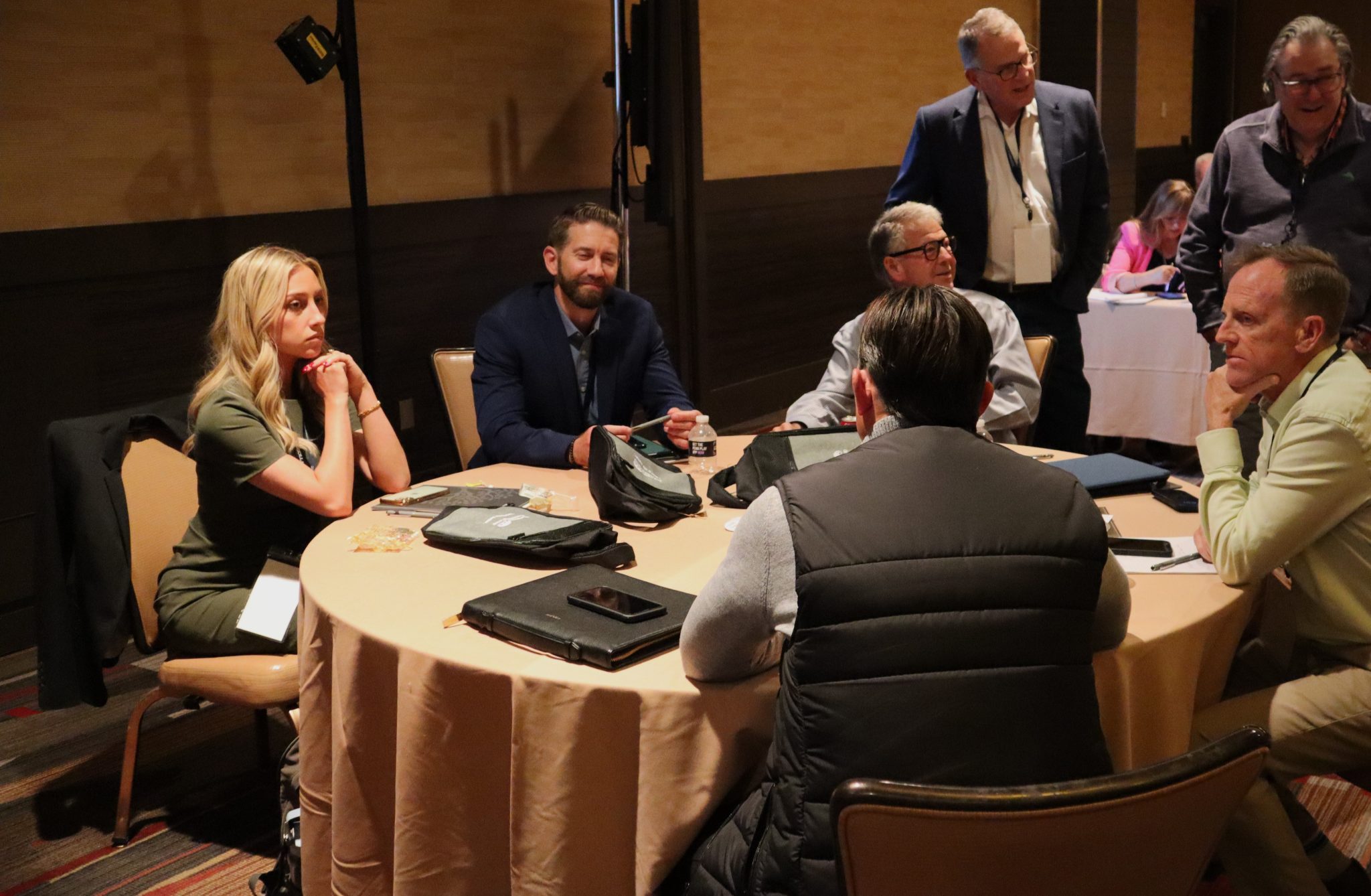 Erin at table with other male advisors